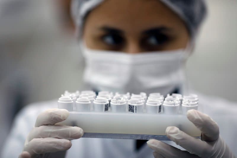 FILE PHOTO: An employee of Brazilian health equipment startup Hi Technologies works in a batch of tests to diagnose the coronavirus disease (COVID-19), at their laboratory in Curitiba