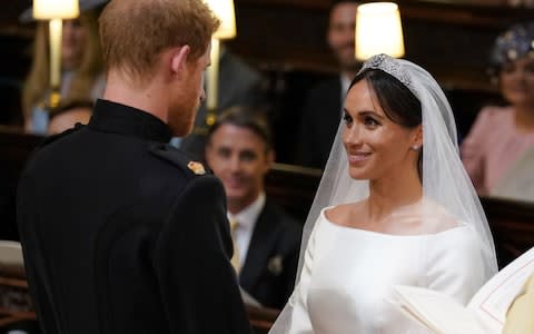 Prince Harry and Meghan Markle during their wedding at St George's Chapel - Credit:  Dominic Lipinski/PA