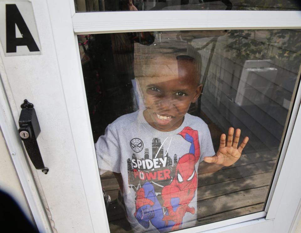 Abel Nimi Jr., 6, answers the door at his family's Sanford home Sept. 11, 2023. Abel Sr. brought his wife and three children to America as asylum seekers.