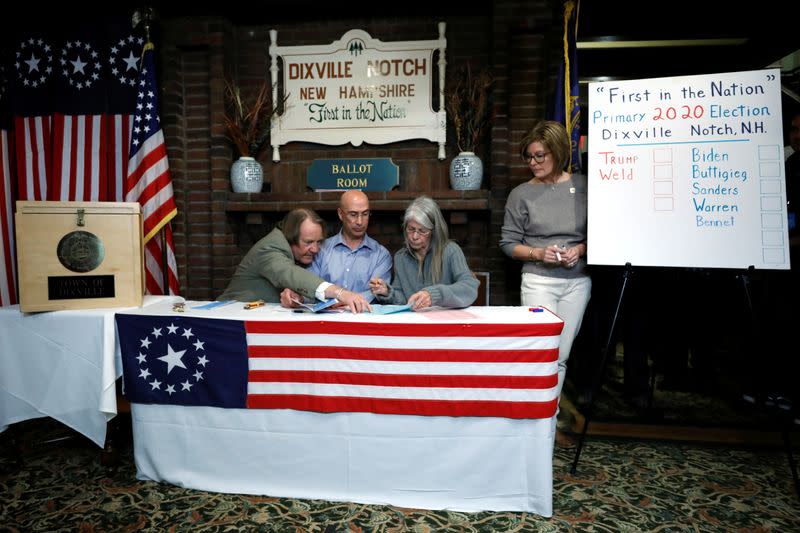 Town moderators Tom Tillotson, Joe Casey and Debra Tillotson count the ballots shortly after midnight in the U.S. Democratic presidential primary at the Hale House at Balsams Hotel in Dixville Notch