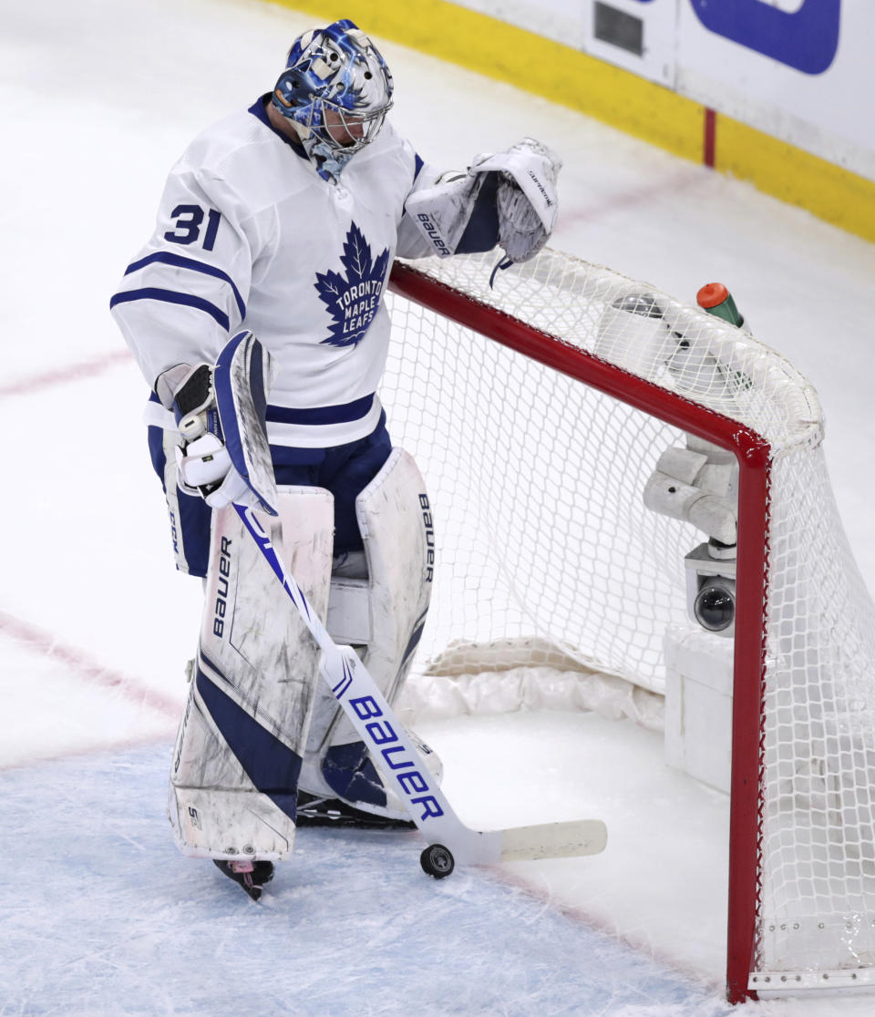 Toronto Maple Leafs goaltender Frederik Andersen (31) retrieves the puck from the net after a goal by Boston Bruins left wing Marcus Johansson during the first period of Game 7 of an NHL hockey first-round playoff series, Tuesday, April 23, 2019, in Boston. (AP Photo/Charles Krupa)