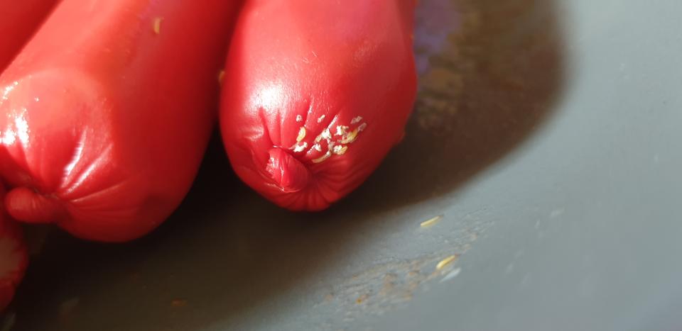 A cluster of live maggots on Aldi frankfurts bought by a NSW mum.