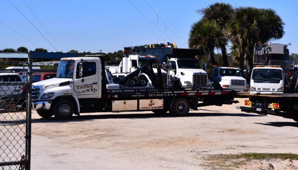 Towing vehicles are parked on the property of Tron's, a towing company in Cocoa. Owners of towing companies are researching just how much prices have gone up to show to commissioners.