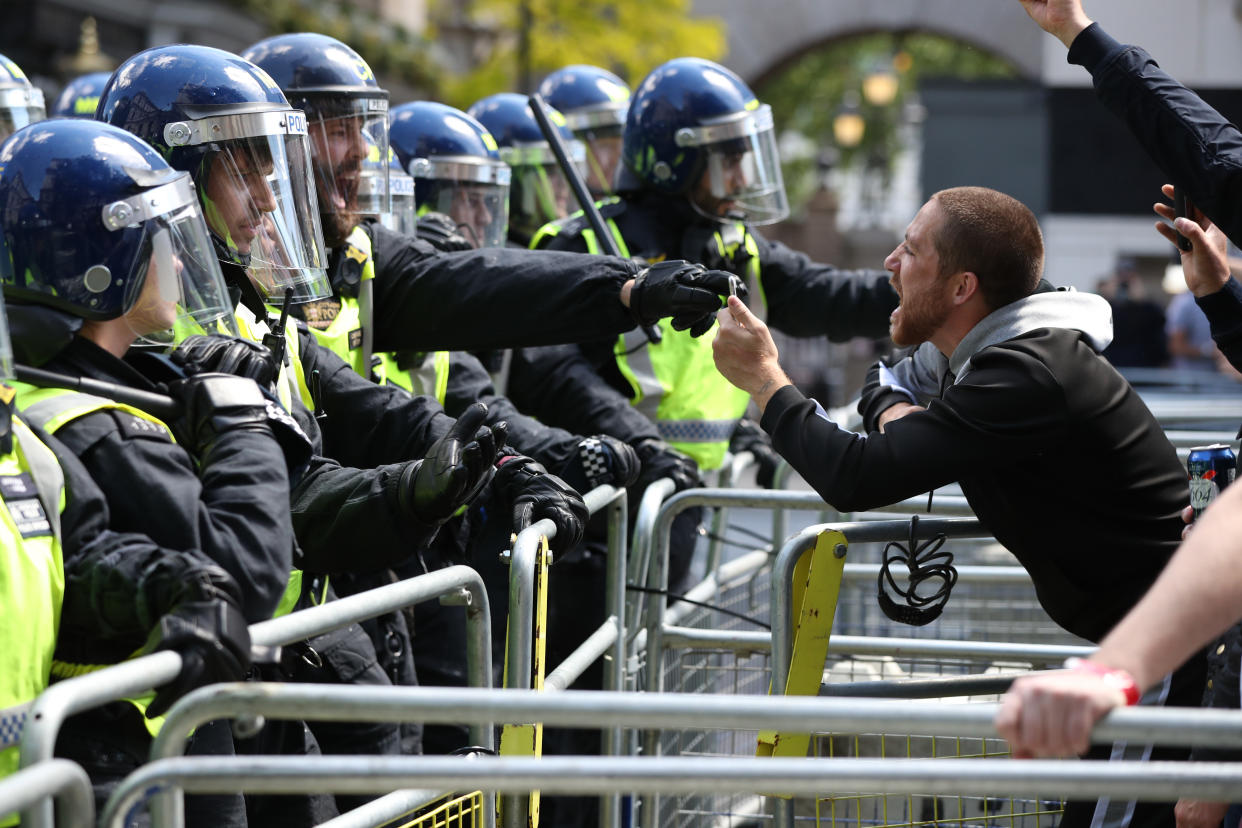 Police are confronted by protesters in Whitehall near Parliament Square, London, during a protest by the Democratic Football Lads Alliance against a Black Lives Matter protest.