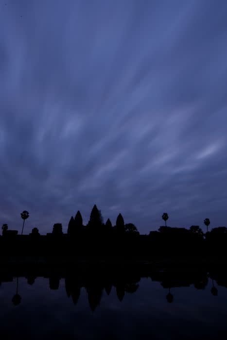 Angkor Wat, the most famous temple in the Angkor Archeological Park, seen against a painted December sky in Siem Reap, Cambodia.