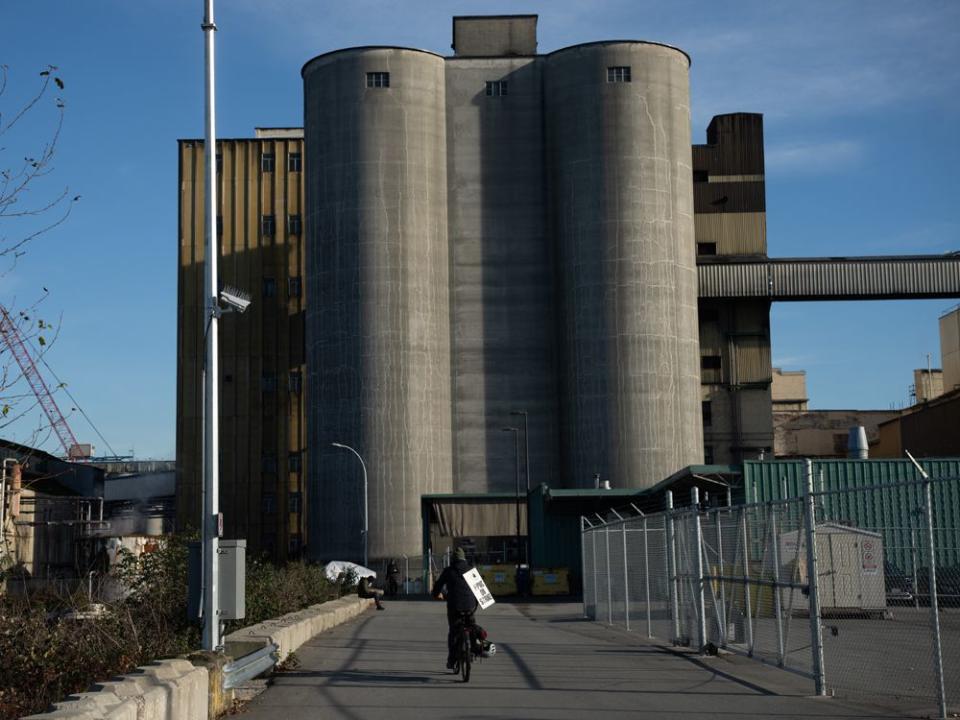  A Rogers Sugar Inc. worker rides his bicycle near the refinery while on strike in Vancouver.