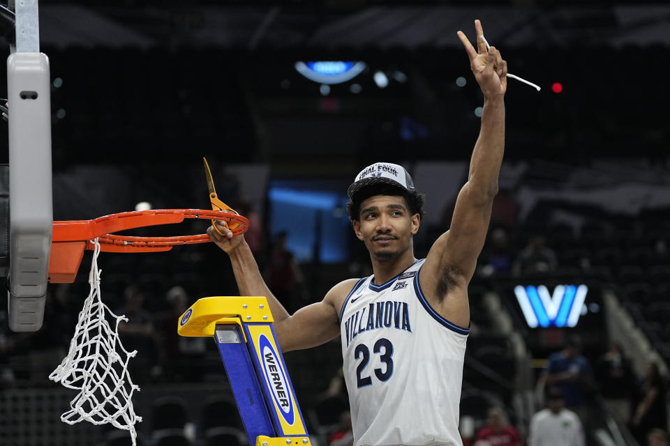 Villanova forward Jermaine Samuels cuts the net after after their win against Houston during a college basketball game in the Elite Eight round of the NCAA tournament on Saturday, March 26, 2022, in San Antonio. (AP Photo/David J. Phillip)