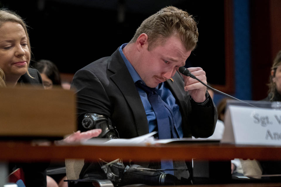 Former Marine Sgt. Tyler Vargas-Andrews, who was gravely injured, losing an arm and a leg in a suicide attack at Hamid Karzai International Airport in Kabul, becomes emotional as he recounts his story during a House Committee on Foreign Affairs hearing on the United States evacuation from Afghanistan on Capitol Hill in Washington, Wednesday, March 8, 2023. (AP Photo/Andrew Harnik)