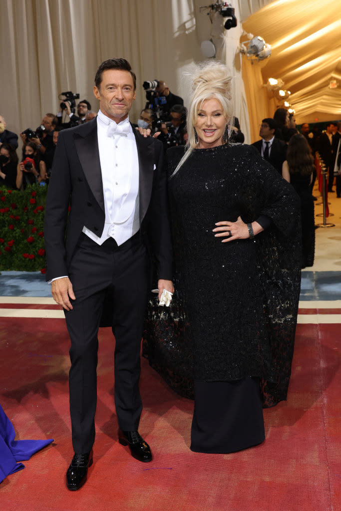 Hugh Jackman and Deborra-Lee Furness stand together and smile on the red carpet