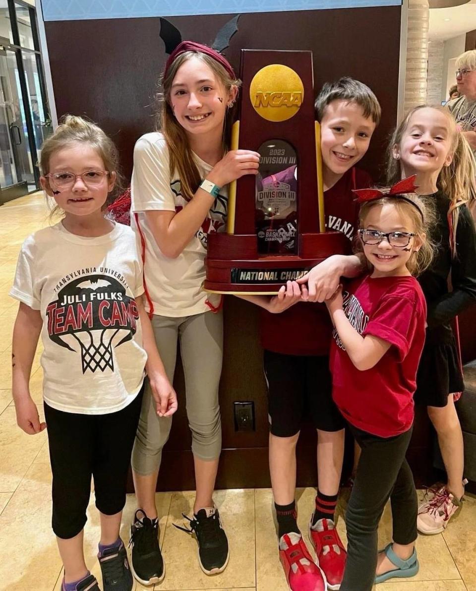 Transylvania women’s basketball coach Juli Fulks’ The five youngest nieces and nephews hold the championship trophy after the Pioneers won the 2023 NCAA Division III Tournament. From left, Lorelei, Kinsey, Christian, Ettilee and Clara Fulks.