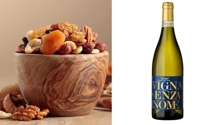 Nuts dried fruit and wine bottle