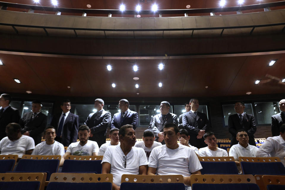 In this July 19, 2019 photo, guards dressed in suits keep an eye on inmates who wait for the start of a classical music session with the symphony orchestra in the national theater in Lima, Peru. Nearly 50 guards kept a close eye on the prisoners during the music class before escorting them back to El Callao, their coastal prison in Lima. (AP Photo/Martin Mejia)