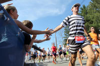 Michael Leibold, from Germany, reaches out to spectators at the start of the 116th running of the Boston Marathon, in Hopkinton, Mass., Monday, April 16, 2012. (AP Photo/Stew Milne)