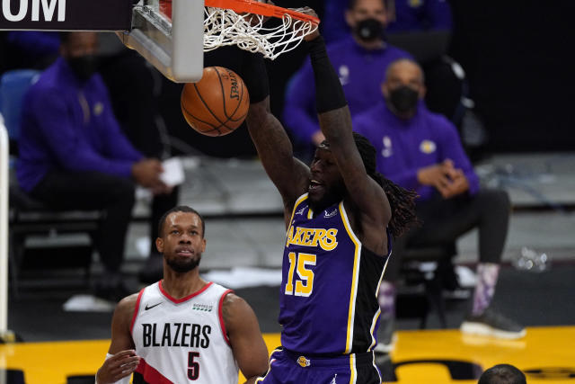 Los Angeles Lakers forward LeBron James (23) points at a team mate during  the second half of an NBA basketball game against the Portland Trail  Blazers Friday, Feb. 26, 2021, in Los