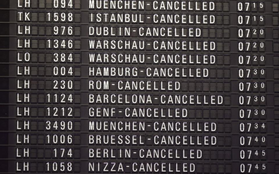 A flight board at a terminal inside at the Frankfurt airport show all flights cancelled - Shutterstock