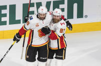 Calgary Flames' Derek Forbort (20) and Sam Bennett (93) celebrate a goal against the Dallas Stars during the second period of a first round NHL Stanley Cup playoff hockey series in Edmonton, Alberta, on Thursday, Aug. 13, 2020. (Jason Franson/The Canadian Press via AP)