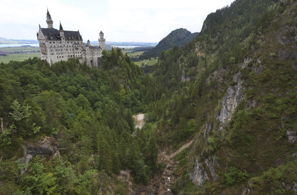 FILE - A view of the Pollat gorge with the Neuschwanstein castle, in background in Schwangau, Germany, June 16, 2023. An American man was convicted of murder and other charges on Monday March 11, 2024 for attacking two women from the U.S. near Neuschwanstein castle in southern Germany last summer and pushing them into a ravine, fatally injuring one of them. He was sentenced to life in prison. (Karl-Josef Hildenbrand/dpa via AP, File)