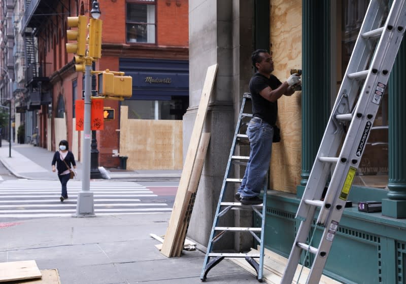 Damaged and boarded up storefronts are seen after protests against the death in Minneapolis police custody of George Floyd, in Manhattan