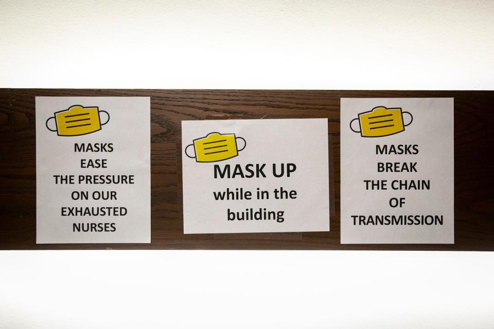 Signs promoting mask use are seen in a staircase, Friday, Sept. 24, 2021, at the English Philosophy Building on the University of Iowa campus in Iowa City, Iowa.