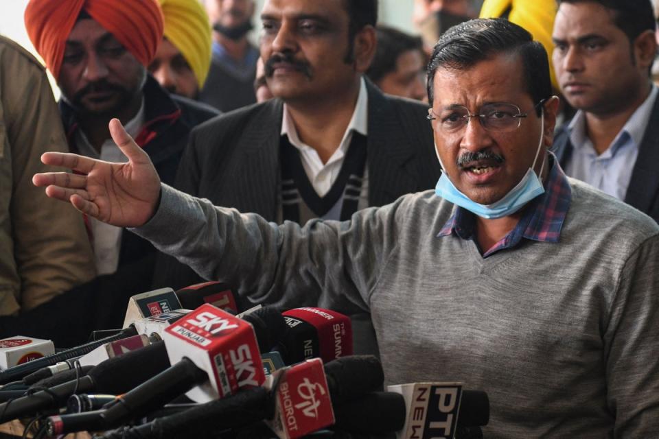 Leader of the Aam Aadmi Party (AAP) and Delhi's chief minister Arvind Kejriwal (C) speaks to the members of the media upon his arrival at Guru Ram Dass Jee International Airport on 24 December 2021 (AFP via Getty Images)