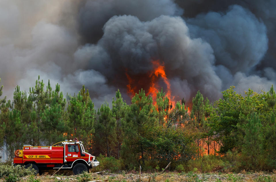 A firefighting truck works to contain a fire in Saint-Magne, as wildfires continue to spread in the Gironde region of southwestern France, August 11, 2022. REUTERS/Stephane Mahe