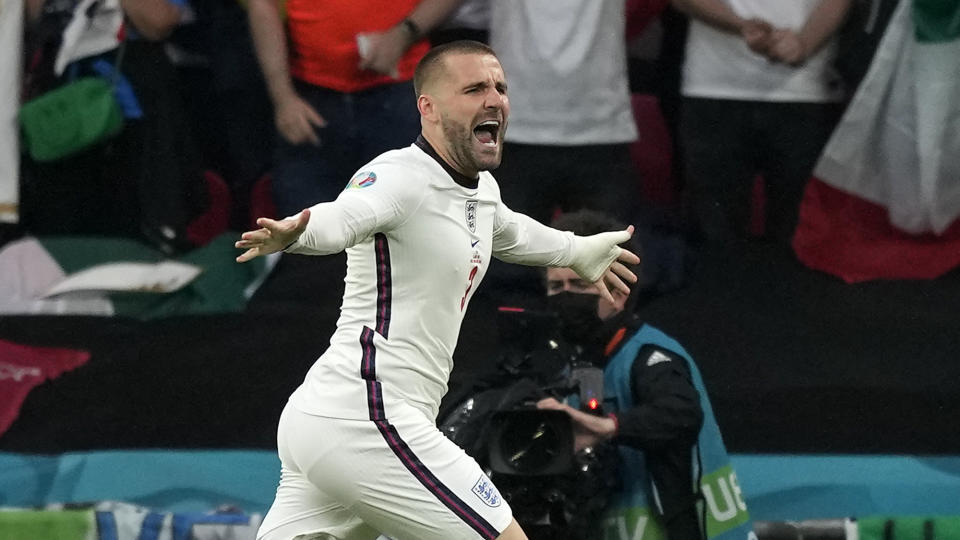 England's Luke Shaw celebrates after scoring the opening goal during the Euro 2020 soccer championship final between England and Italy at Wembley stadium in London, Sunday, July 11, 2021. (AP Photo/Frank Augstein, Pool)