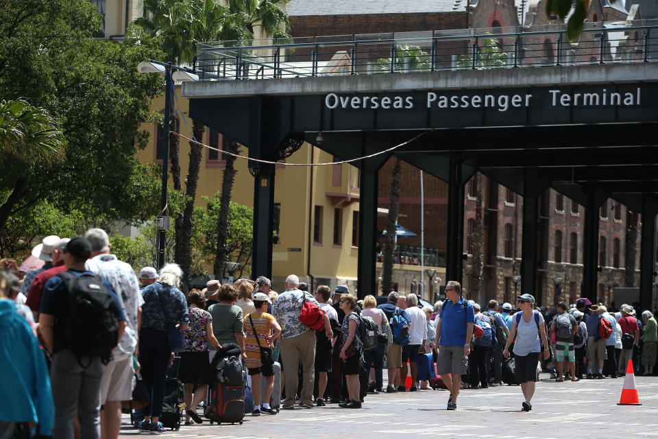 Passengers queue at Sydney's Overseas Passenger Terminal on February 14, 2020, when the Norwegian Jewel cruise ship was put into lockdown over coronavirus fears.