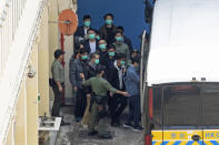 FILE - In this Tuesday, March 2, 2021, file photo, some of the 47 democracy activists are escorted by Correctional Services officers in Hong Kong. In the semi-autonomous city of Hong Kong, China is moving to eliminate the possibility of opposition politicians gaining office, saying only patriots loyal to the Communist Party can have a role in government. (AP Photo/Kin Cheung, File)