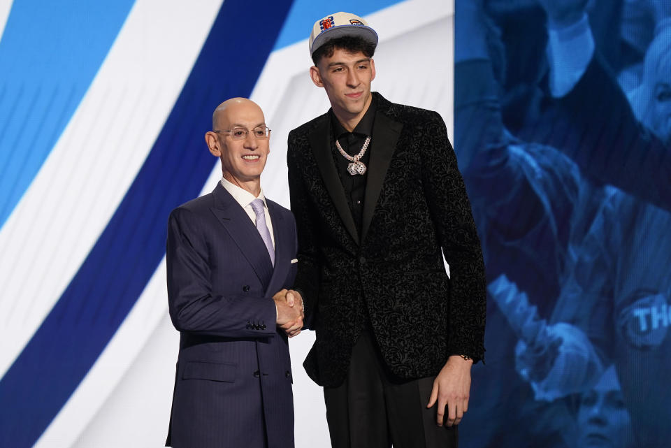 Chet Holmgren, right, poses for photos with NBA Commissioner Adam Silver after being selected second overall in the NBA basketball draft by the Oklahoma Thunder, Thursday, June 23, 2022, in New York. (AP Photo/John Minchillo)