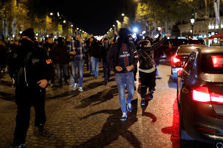 French plainclothes policemen gather during an unauthorised protest against anti-police violence on the Champs Elysees in Paris, France, early October 20, 2016. REUTERS/Benoit Tessier