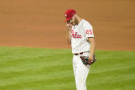 Philadelphia Phillies pitcher Zack Wheeler wipes his face after giving up a two-run home run to San Francisco Giants' Tommy La Stella during the fifth inning of a baseball game, Tuesday, April 20, 2021, in Philadelphia. (AP Photo/Matt Slocum)