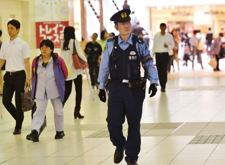 A policeman is seen patrolling a Tokyo railway station