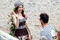 <p>Lily Collins gives her costar a high five while filming <em>Emily in Paris </em>in Saint-Jean-Cap-Ferrat, France on Tuesday. </p>