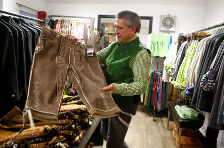 The owner of Witzky Trachten, Wolfgang Witzky, shows a Lederhose (leather trousers) in his shop in Vienna, Austria, November 25, 2016. Picture taken November 25, 2016. REUTERS/Leonhard Foeger