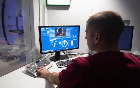 A radiographer demonstrates the control room at the NHS's new Proton Beam therapy centre at The Christie hospital in Manchester - Credit: PA