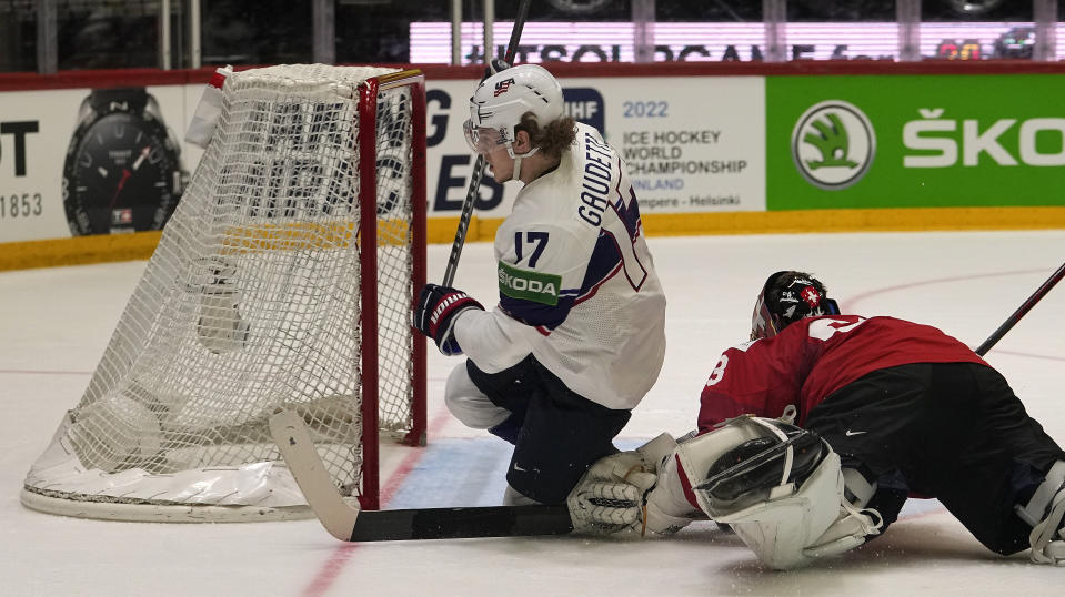Adam Gaudette of the United States scores the second goal against Switzerland's keeper Leonardo Genoni during the Hockey World Championship quarterfinal match between Switzerland and USA in Helsinki, Finland, Thursday May 26, 2022. (AP Photo/Martin Meissner)