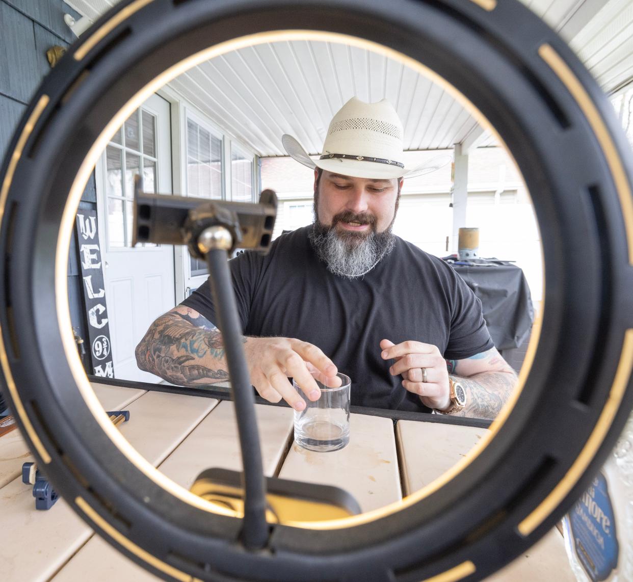 Ryan Shaner, a Stark County-based TikTok content creator and influencer, prepares a drink for a TikTok video at his Navarre home.