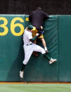 Outfielder Eric Byrnes #22 of the Oakland Athletics grabs a fan who ran onto the field during the game against the New York Yankees at McAfee Coliseum on May 15, 2005 in Oakland, California. (Photo by Jed Jacobsohn/Getty Images)