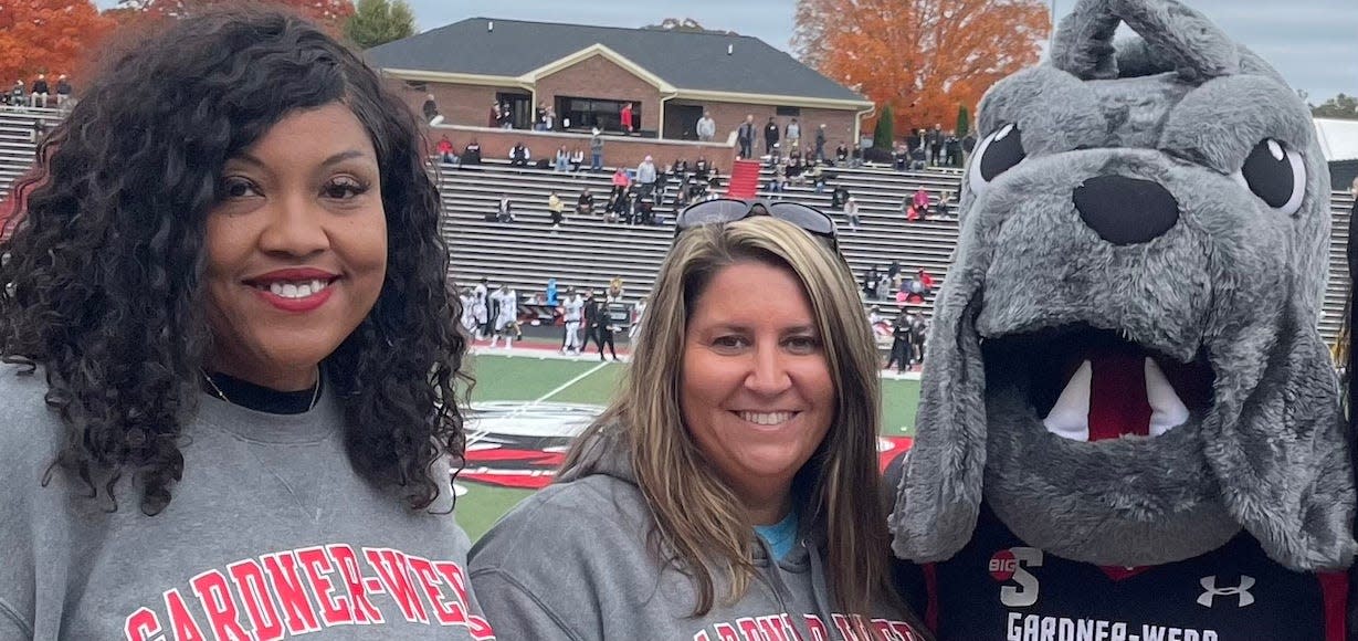 Adriene Crego, left, and Nicole Childers stand with the GWU mascot. The two shared their journeys to getting teaching degrees.