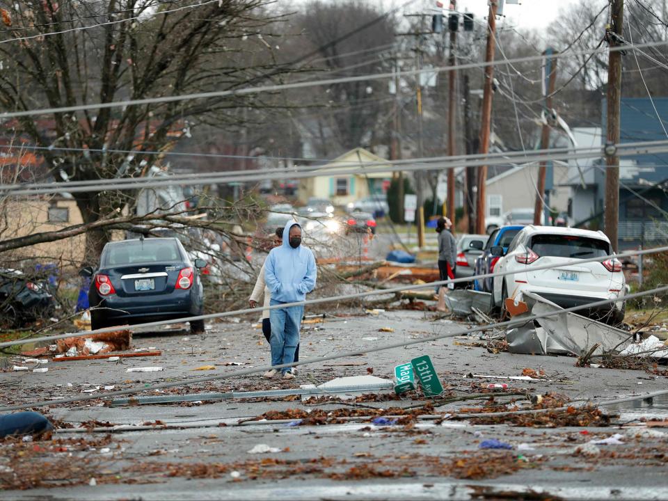 Bowling Green, Kentucky, residents look at the damage following a tornado that struck the area on December 11, 2021 (AFP via Getty Images)