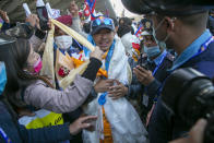 Nirmal Purja one of the team member of the all-Nepalese mountaineering team that became the first to scale Mount K2 in winter receives a scarf as they arrive at Tribhuwan International airport in Kathmandu, Nepal, Tuesday, Jan. 26, 2021. (AP Photo/Niranjan Shrestha)