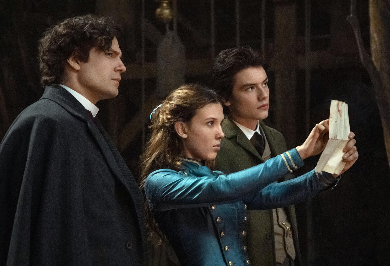 Henry Cavill as Sherlock Holmes, Millie Bobby Brown as Enola Holmes and Louis Partridge as Tewkesbury in 