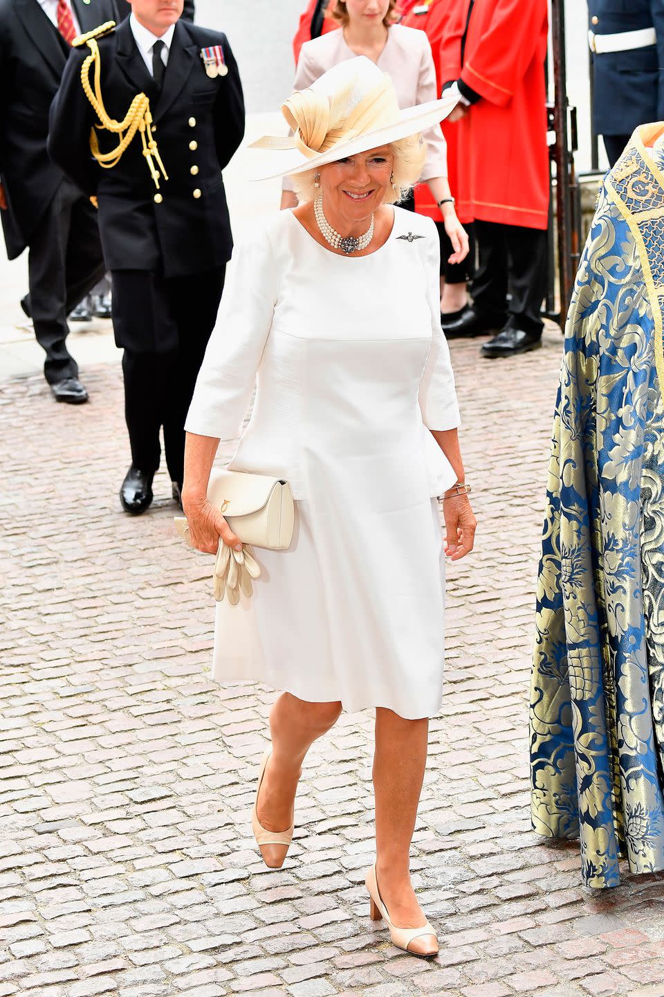 <p>Camilla Parker Bowles wore a simple white dress with cream accessories for the occasion at Westminster Abbey.</p>