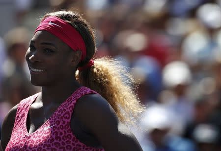 Serena Williams of the U.S. smiles after defeating compatriot Vania King at the 2014 U.S. Open tennis tournament in New York, August 28, 2014. REUTERS/Mike Segar