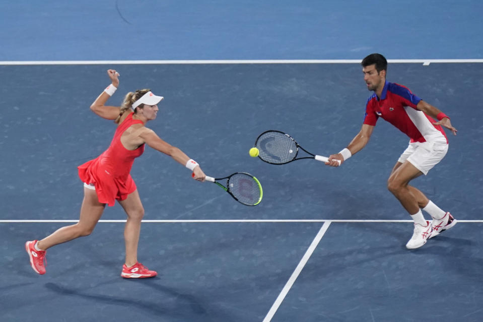 The Serbian mixed doubles team of Nina Stojanovic, left, and Novak Djokovic play during the quarterfinals of the tennis competition at the 2020 Summer Olympics, Thursday, July 29, 2021, in Tokyo, Japan. (AP Photo/Seth Wenig)