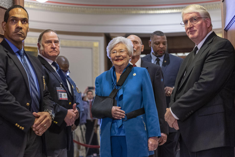 Gov. Kay Ivey, center, is introduced and invited into the chamber to give the State of the State Address to a joint session of the Alabama Legislature on Tuesday, Feb. 4, 2020, in the old house chamber of the Alabama State Capitol in Montgomery, Ala. (AP Photo/Vasha Hunt)