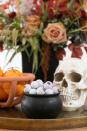 <p>Use a small black bowl to pose as a mini cauldron and fill it with edible "eyeballs," aka chocolates wrapped in bloodshot eye motif foil, as seen in this Halloween spread styled by <a href="https://sugarandcharm.com/inexpensive-halloween-decorating-ideas" rel="nofollow noopener" target="_blank" data-ylk="slk:Sugar & Charm;elm:context_link;itc:0;sec:content-canvas" class="link ">Sugar & Charm</a>. Or, if you can't find those, glue googly eyes to the candy wrappers</p><p><a class="link " href="https://www.candywarehouse.com/googly-eyes-foiled-double-crisp-chocolate-eyeballs-2lb-bag" rel="nofollow noopener" target="_blank" data-ylk="slk:BUY NOW;elm:context_link;itc:0;sec:content-canvas">BUY NOW</a><strong><em> Eyeball Chocolates, $14</em></strong></p>
