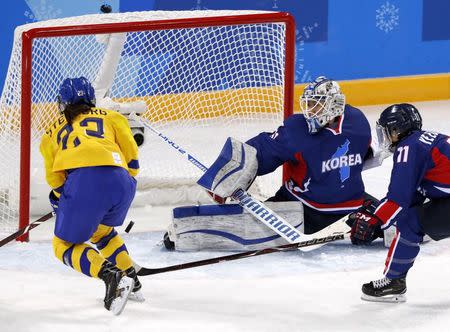 Ice Hockey – Pyeongchang 2018 Winter Olympics – Women Preliminary Round Match - Sweden v Korea - Kwandong Hockey Centre, Gangneung, South Korea – February 12, 2018 - Rebecca Stenberg of Sweden scores a goal against goalkeeper Shin So-jung of Korea. REUTERS/Grigory Dukor