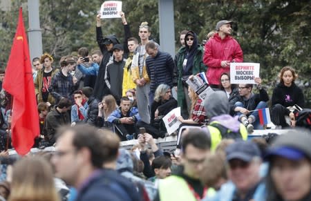 People attend a rally to demand authorities allow opposition candidates to run in a local election in Moscow