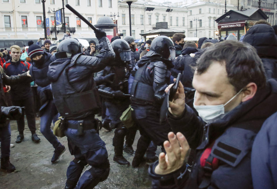 Police clash with demonstraters during a protest against the jailing of opposition leader Alexei Navalny in People gather in St.Petersburg, Russia, Saturday, Jan. 23, 2021. Russian police are arresting protesters demanding the release of top Russian opposition leader Alexei Navalny at demonstrations in the country's east and larger unsanctioned rallies are expected later Saturday in Moscow and other major cities. (AP Photo/Dmitri Lovetsky)